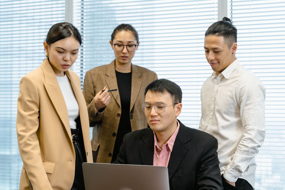 Recruitment consultants reviewing a laptop together by the window