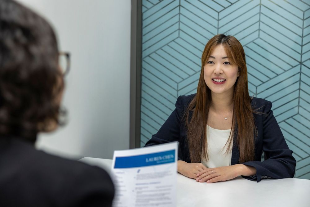 A smiling candidate in an interview with a recruiter
